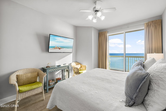 bedroom with access to exterior, ceiling fan, and wood finished floors