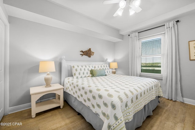 bedroom with baseboards, wood finished floors, and ceiling fan