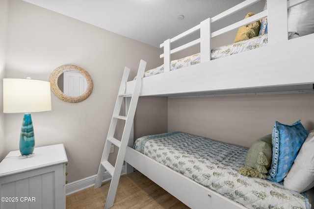bedroom with wood finished floors and baseboards