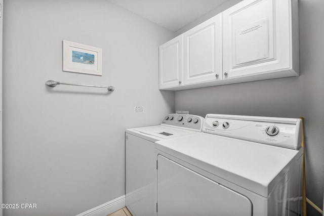 washroom with washer and dryer and cabinet space