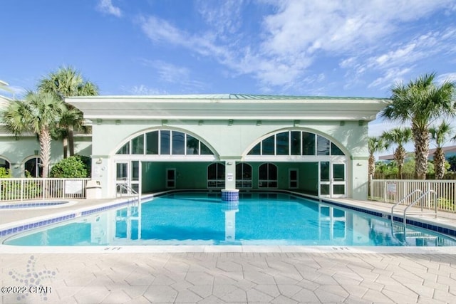 pool with fence and a patio