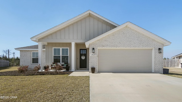 view of front of home with an attached garage, brick siding, concrete driveway, board and batten siding, and a front yard