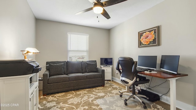 office featuring light wood-style flooring, baseboards, and a ceiling fan