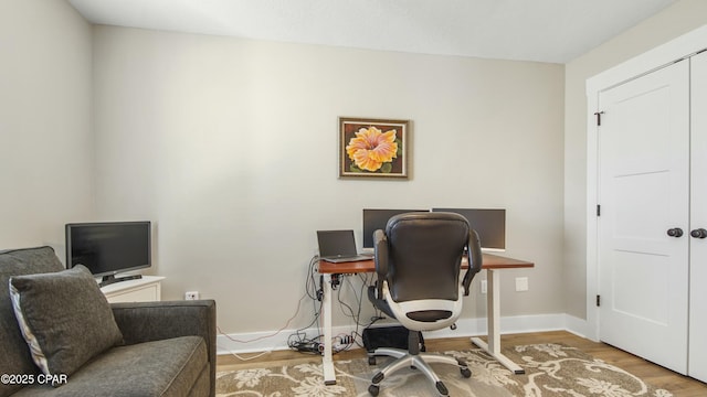 office area with wood finished floors and baseboards