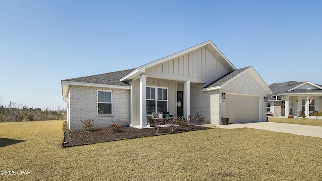 view of front of house featuring board and batten siding, brick siding, driveway, and a front lawn