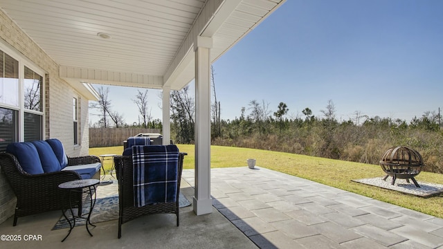 view of patio / terrace featuring fence and a fire pit