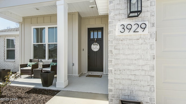 property entrance with a porch and a garage