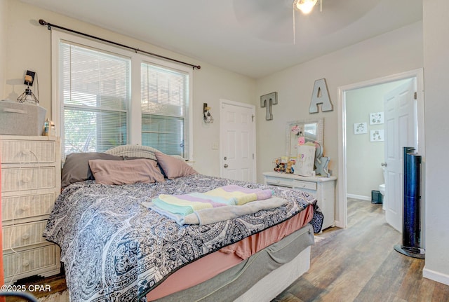 bedroom with light wood-style flooring, baseboards, and ceiling fan