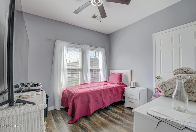 bedroom with wood finished floors, visible vents, and a ceiling fan