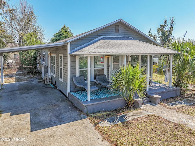 view of front of property with driveway, a porch, and roof with shingles