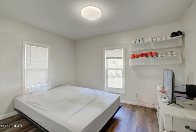 bedroom featuring dark wood-type flooring and baseboards