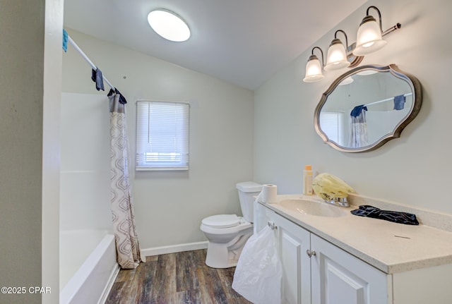 full bathroom with lofted ceiling, toilet, wood finished floors, vanity, and shower / tub combo with curtain