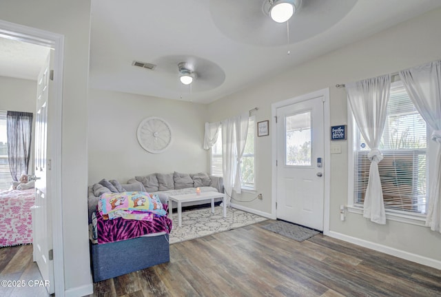 foyer with a wealth of natural light, ceiling fan, visible vents, and wood finished floors