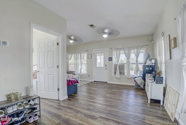 entryway with baseboards, ceiling fan, wood finished floors, and a healthy amount of sunlight