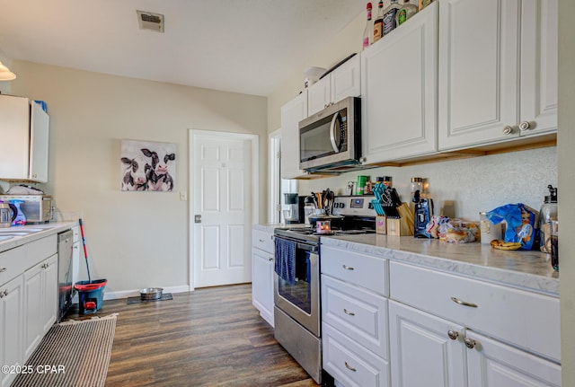 kitchen featuring dark wood-style floors, white cabinetry, stainless steel appliances, and light countertops