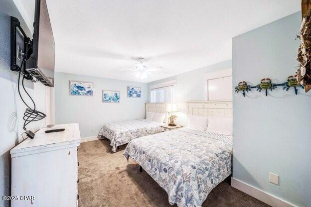 carpeted bedroom featuring a ceiling fan and baseboards