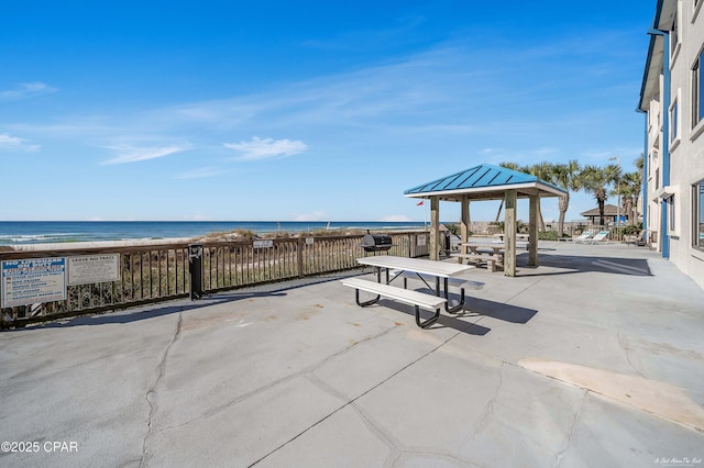 view of patio featuring a gazebo and a water view