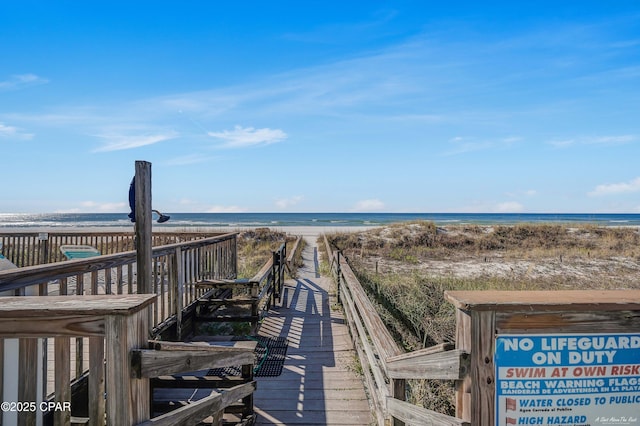 surrounding community featuring a water view and a view of the beach