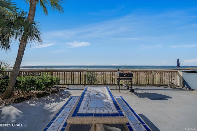 view of patio with a water view and grilling area