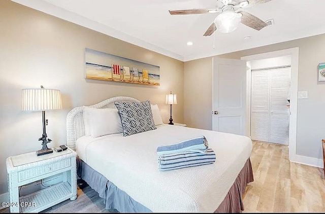 bedroom with light wood-style floors, ceiling fan, baseboards, and recessed lighting