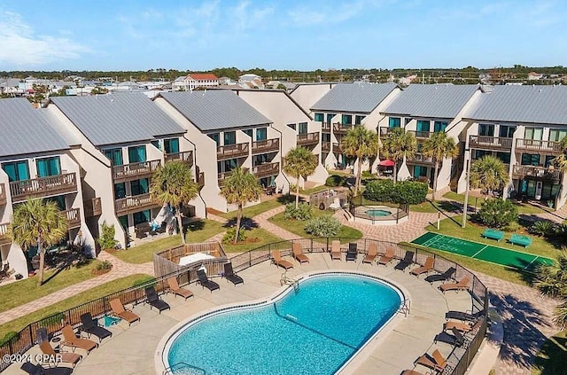 pool featuring a patio area, fence, and a residential view