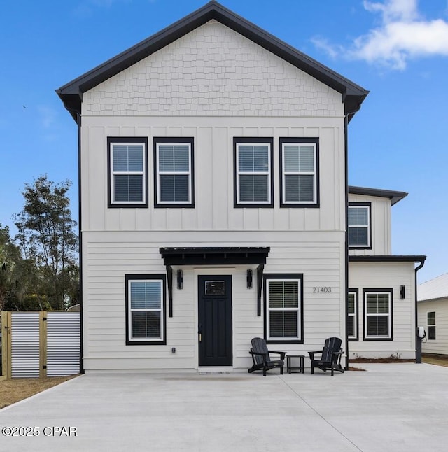 view of front of property with board and batten siding and fence