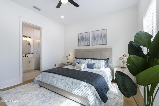 21403 Sunset Ave, Panama City Beach, FL 32413 - bedroom with light wood-style floors, connected bathroom, recessed lighting, a ceiling fan, and a sink