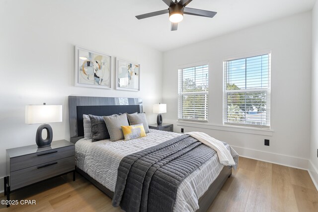 21403 Sunset Ave, Panama City Beach, FL 32413 - bedroom featuring baseboards, wood finished floors, and ceiling fan