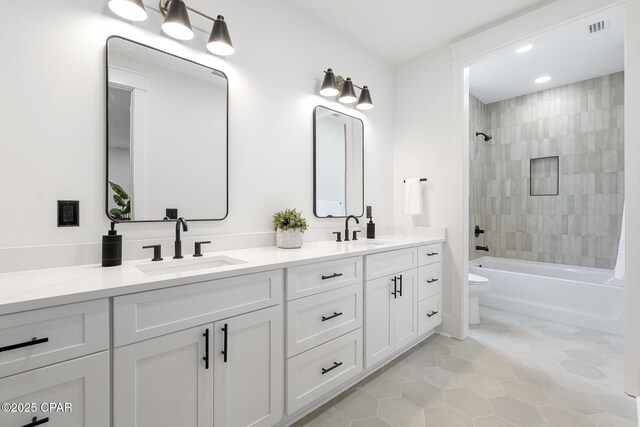 21403 Sunset Ave, Panama City Beach, FL 32413 - full bath with toilet, double vanity, tile patterned flooring,  shower combination, and recessed lighting