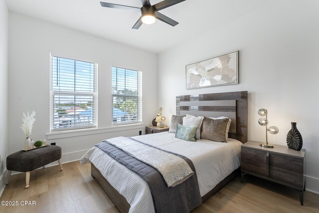 21403 Sunset Ave, Panama City Beach, FL 32413 - bedroom featuring light wood-type flooring, baseboards, and a ceiling fan