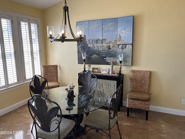 dining area featuring baseboards and a chandelier