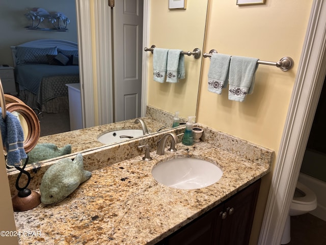 bathroom featuring toilet and vanity