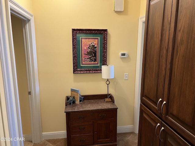 hall with tile patterned floors and baseboards