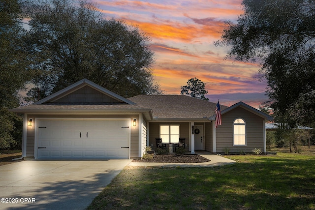 view of front of property with a garage, concrete driveway, a lawn, and a porch