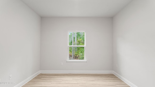 empty room with light wood-type flooring and baseboards