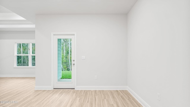 spare room featuring wood finished floors and baseboards