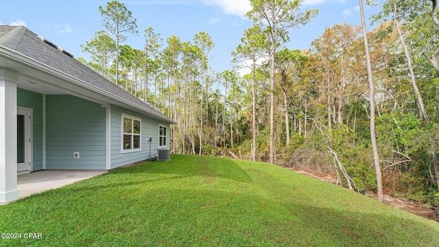 view of yard with a patio area and central air condition unit