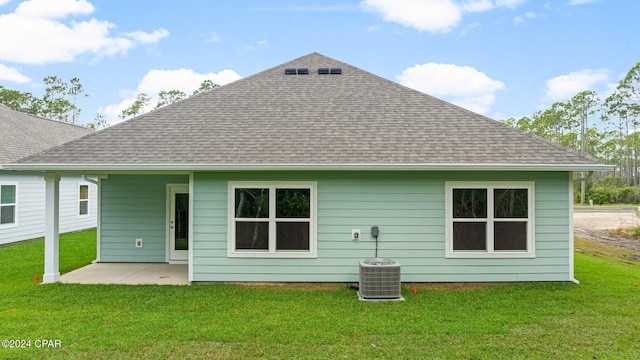 back of house with a patio area, a shingled roof, central AC, and a yard