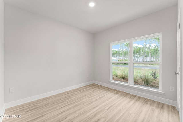 empty room with light wood-style floors and baseboards