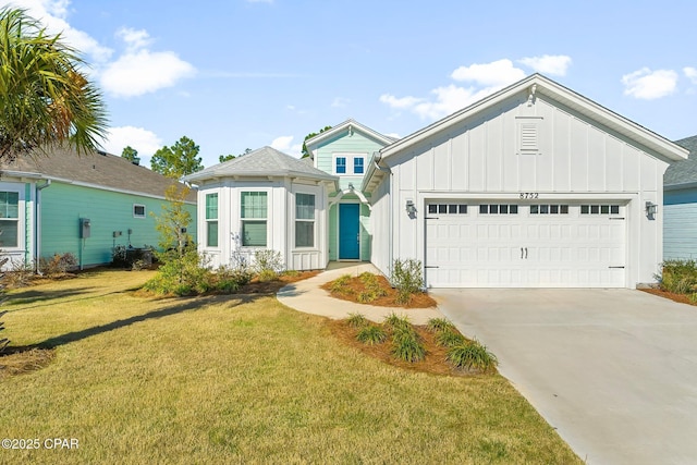 view of front of house featuring a garage, board and batten siding, concrete driveway, and a front yard