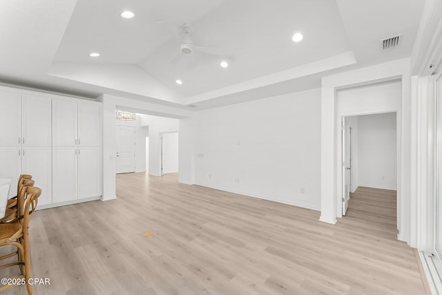 unfurnished living room featuring visible vents, lofted ceiling, light wood-style flooring, and ceiling fan with notable chandelier