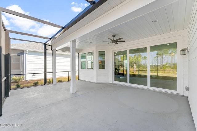 unfurnished sunroom with ceiling fan