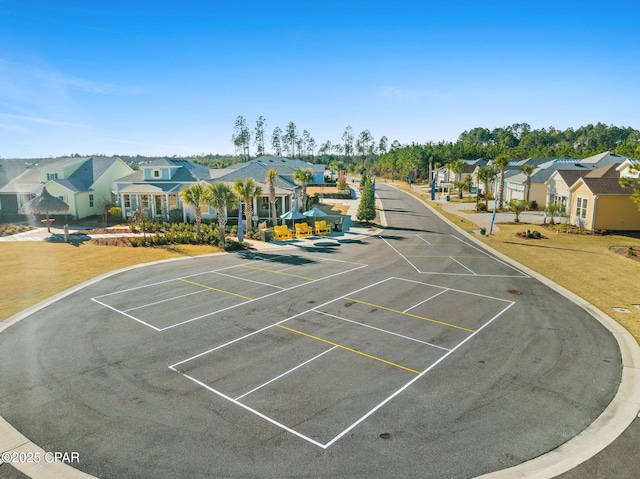 uncovered parking lot featuring a residential view