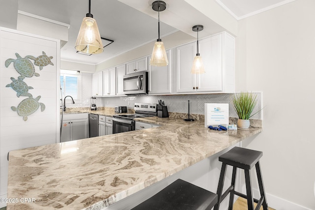 kitchen featuring tasteful backsplash, ornamental molding, light stone countertops, stainless steel appliances, and a sink