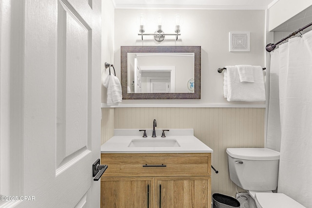 full bathroom with visible vents, toilet, ornamental molding, wainscoting, and vanity