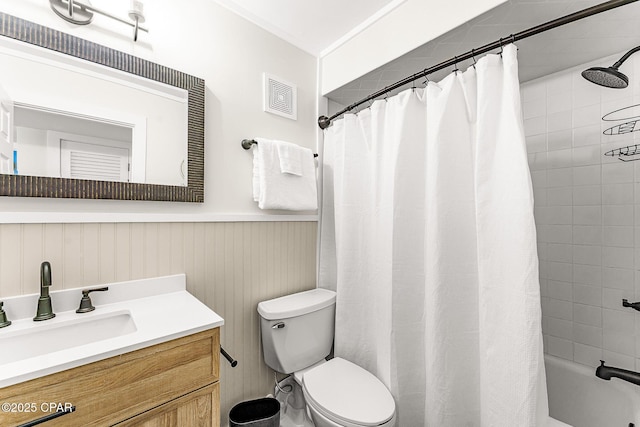 bathroom with shower / bath combo, visible vents, toilet, a wainscoted wall, and vanity