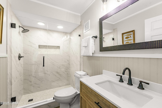 bathroom featuring visible vents, toilet, ornamental molding, vanity, and a shower stall