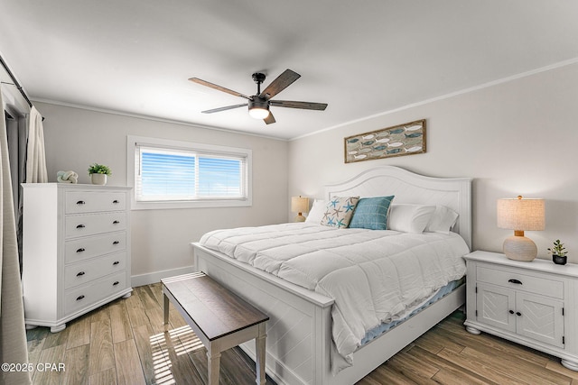 bedroom with a ceiling fan, light wood-type flooring, crown molding, and baseboards