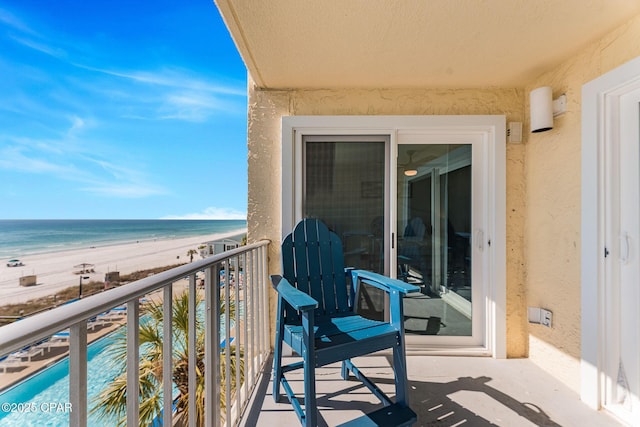 balcony featuring a water view and a view of the beach