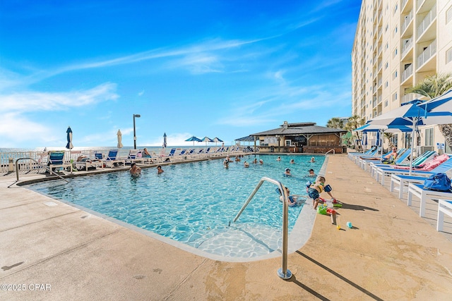 view of swimming pool featuring a water view